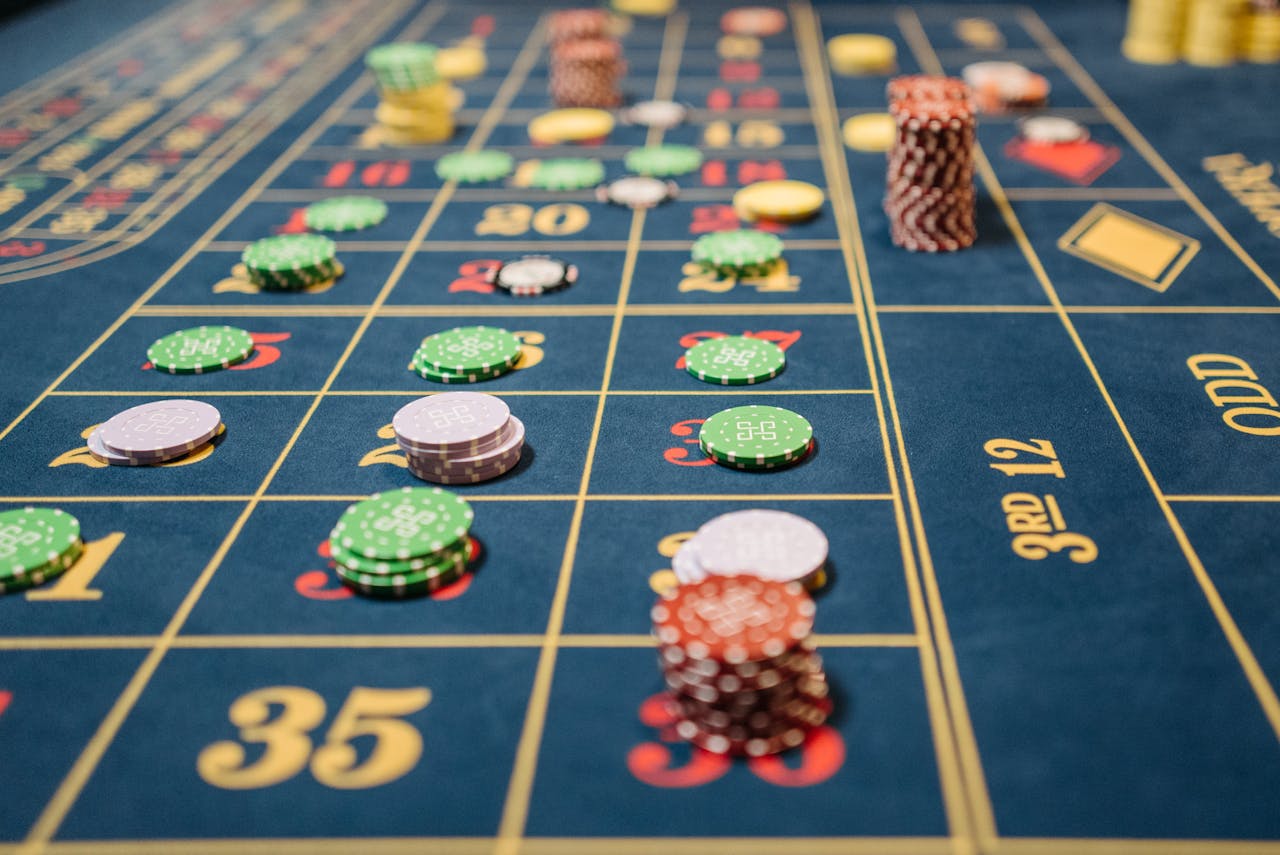 services-03 Close-up of a roulette table with colorful poker chips, capturing the thrill of casino gambling.